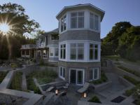 Carr project - nautical New England waterfront home - basement patio at sunset