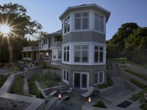 Carr project - nautical New England waterfront home - basement patio at sunset