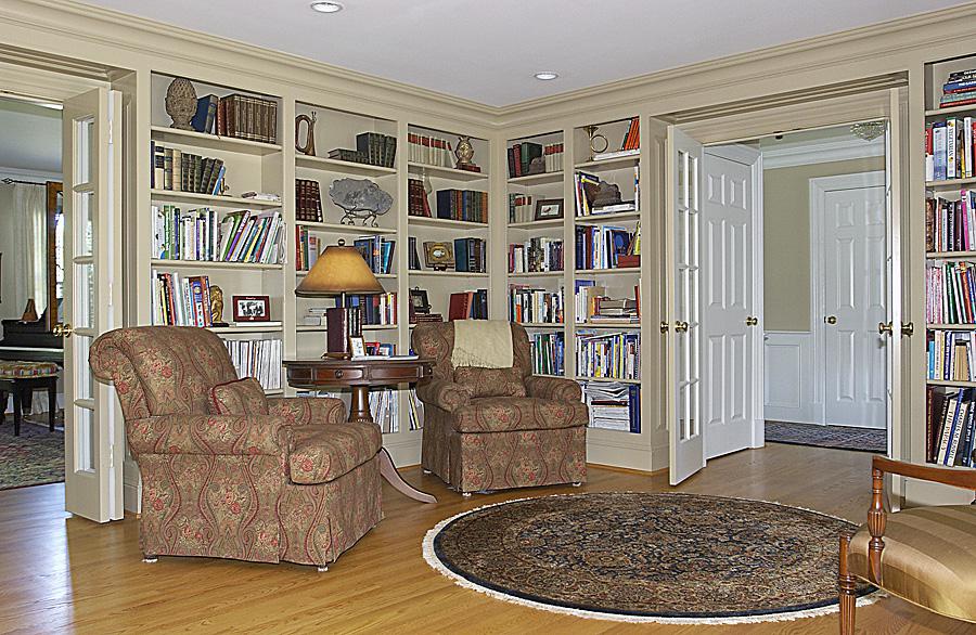Small library with wood built-ins and comfortable settees