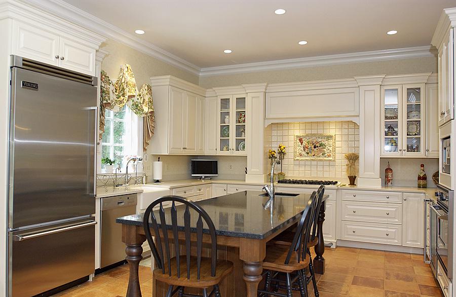 Bright and white farmhouse style kitchen with stainless steel appliances
