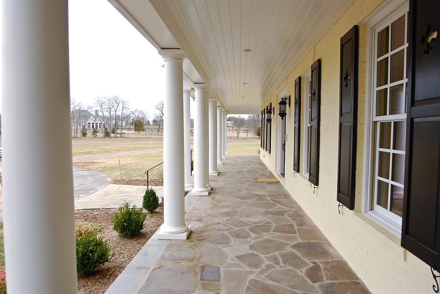 An expansive front porch on Sugarland Lane by Frank M Bell