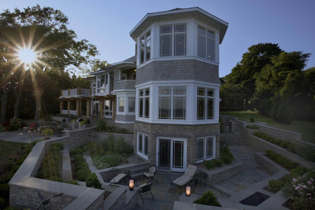 Carr project - nautical New England waterfront home - basement patio at sunset